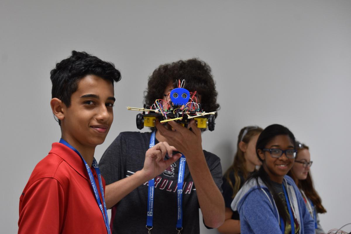 Image of students showing their robots.