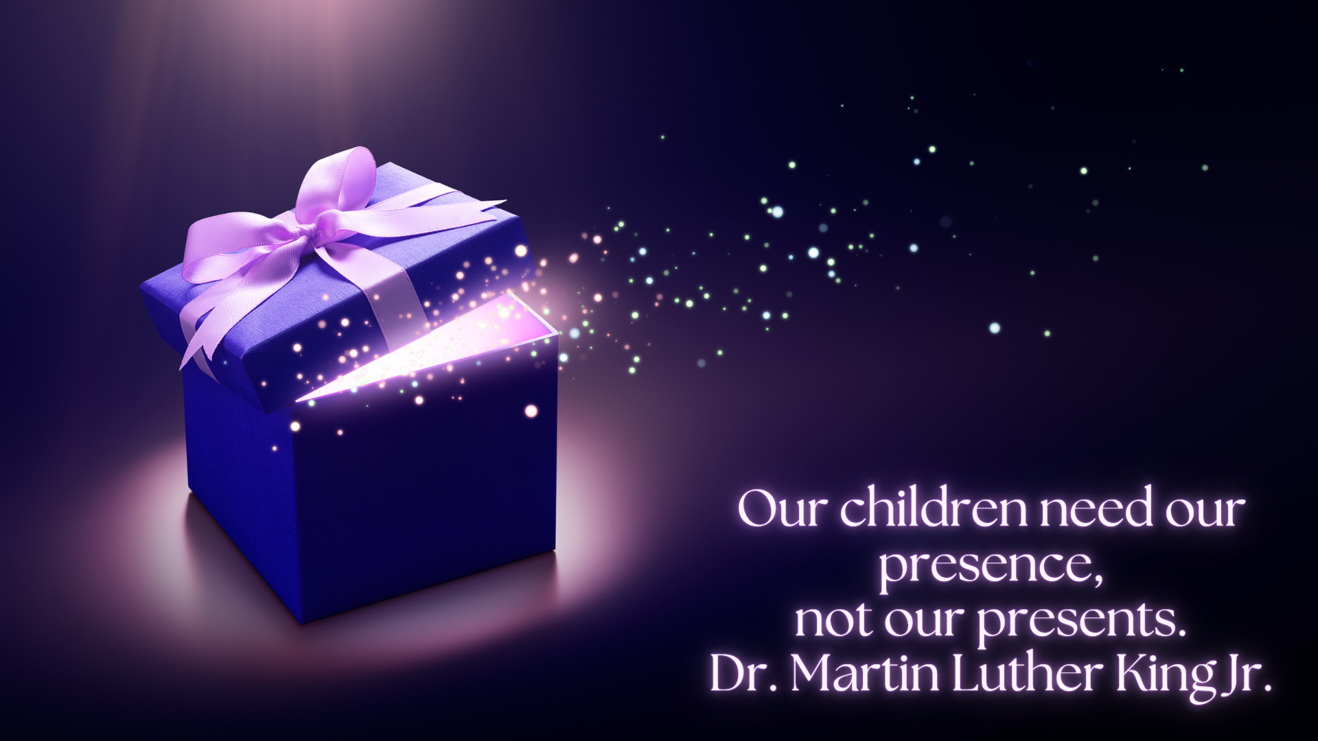 Contest submission titled "A Gift." An image of an open gift box with sparkling circles emerging from it, with text that reads "Our children need our presence, not our presents. Dr. Martin Luther King Jr."